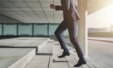Man wearing suit runs up the stairs