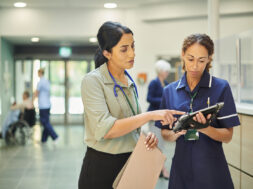 hospital colleagues checking medical records database