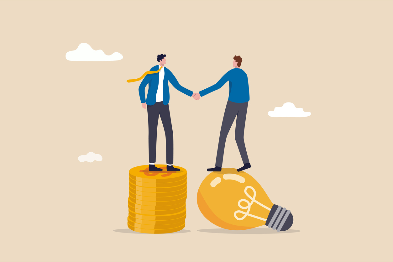 Idea pitching, fund raising and venture capital, selling business or merger agreement concept, entrepreneur businessman standing on lightbulb idea lamp shaking hands with VC on money coins stack.