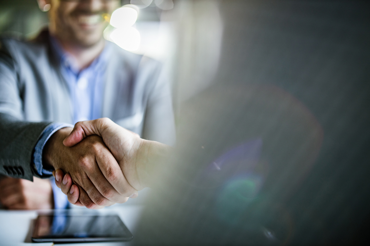 Close up of businessmen came to an agreement in the office.