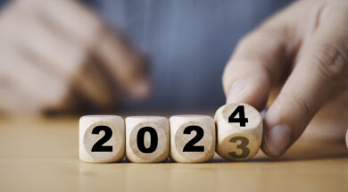 Hand flipping of 2023 to 2024 on wooden block cube for preparation new year change and start new business target strategy concept.