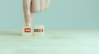 2023 Recap economy, business, financial summary, business review concept. For business planning in 2024. Replay icon and 2023 on wooden cubes on smart grey background and copy space.