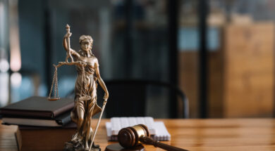 Statue of lady justice on desk of a judge or lawyer.