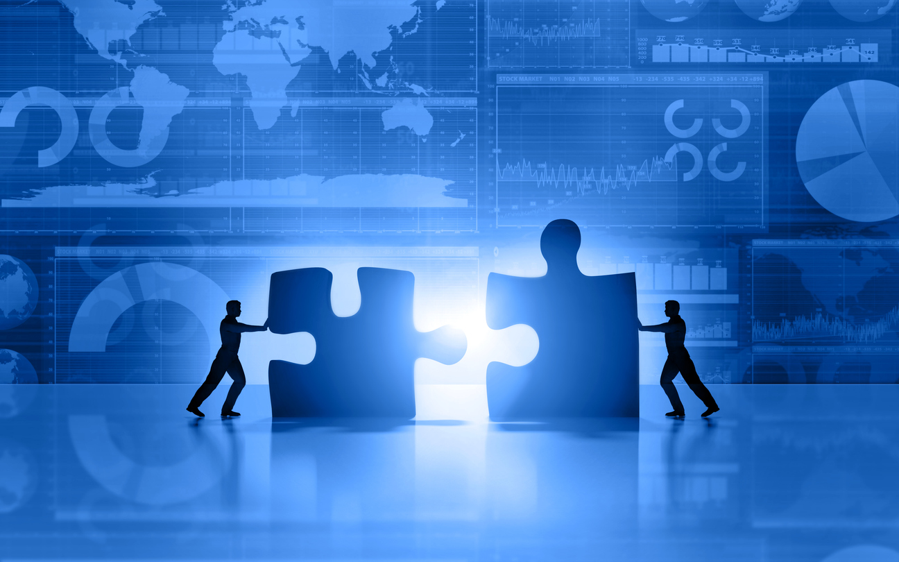 Business men teamwork joining puzzle on blue background