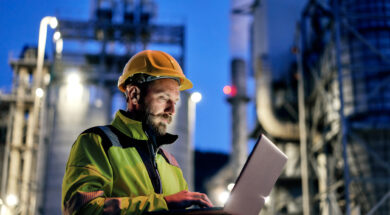 Male engineer using laptop during night shift.