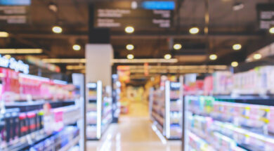 supermarket aisle with cosmetic healthcare product shelves interior defocused blur background