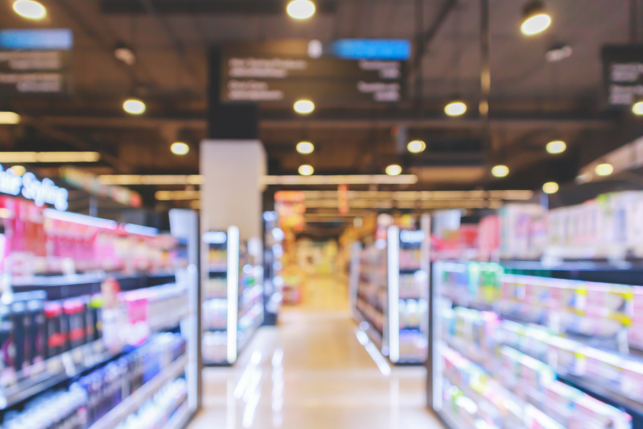 supermarket aisle with cosmetic healthcare product shelves interior defocused blur background