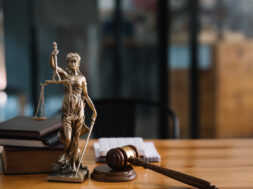 Statue of lady justice on desk of a judge or lawyer.