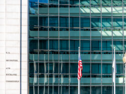 US United States Securities and Exchange Commission SEC entrance architecture modern building sign, logo, american flag, glass windows