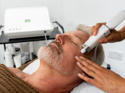 Man at the spa getting a facial laser treatment