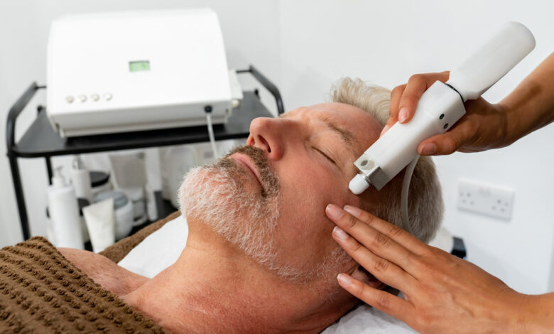 Man at the spa getting a facial laser treatment