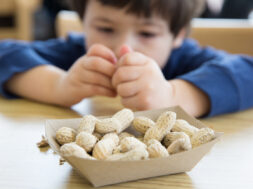 Little boy eating peanuts