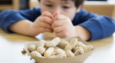 Little boy eating peanuts