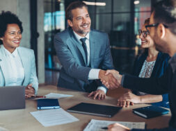 Businessmen shaking hands across the table