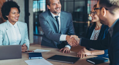 Businessmen shaking hands across the table