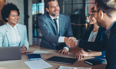 Businessmen shaking hands across the table