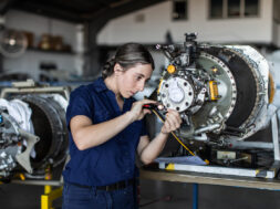 Real life young female aircraft engineer apprentice at work