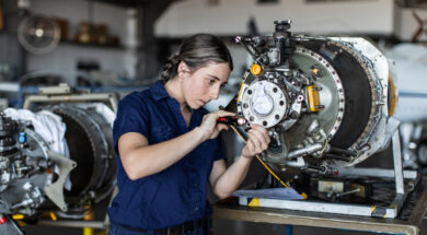 Real life young female aircraft engineer apprentice at work