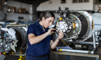 Real life young female aircraft engineer apprentice at work