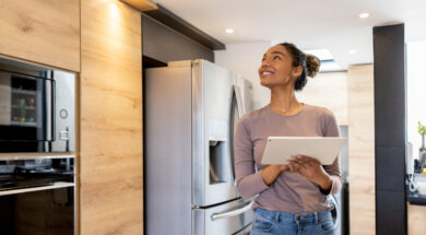 Woman controlling the lights of her smart house using an automated system