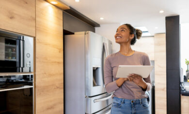 Woman controlling the lights of her smart house using an automated system