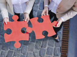 Germany, Businesswomen holding jigsaw pieces