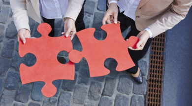 Germany, Businesswomen holding jigsaw pieces