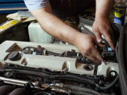 Mechanic working on car engine