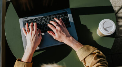 Close-up of hands typing on a laptop computer