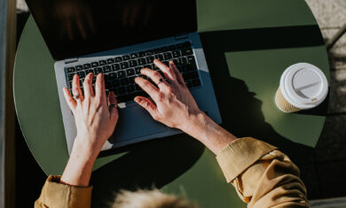 Close-up of hands typing on a laptop computer