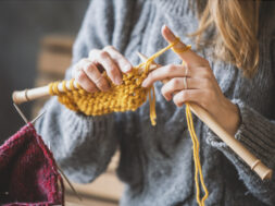 Close up on woman’s hands knitting