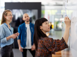 Businesswoman explaining new project plan to team in office