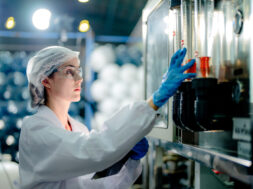 scientist worker checking the quality of Reverse osmosis machine system at the industrial factory. Female worker recording data at the control panel with measure pressure for recycle portable plant.