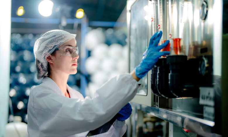 scientist worker checking the quality of Reverse osmosis machine system at the industrial factory. Female worker recording data at the control panel with measure pressure for recycle portable plant.