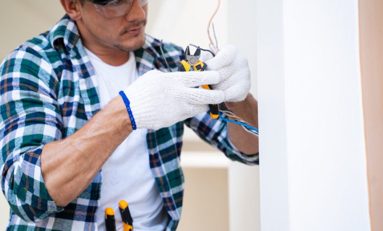 Electrician prepares the installation of electrical wiring.