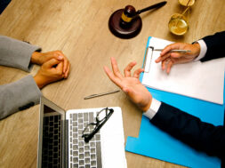 Business people and lawyers discussing contract papers sitting at the table. Concepts of law, legal services