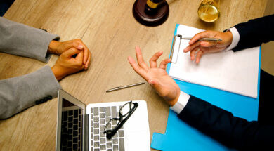 Business people and lawyers discussing contract papers sitting at the table. Concepts of law, legal services