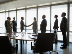 Business people shaking hands in conference room