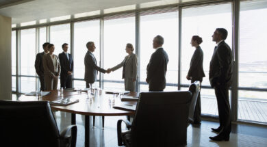 Business people shaking hands in conference room