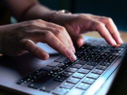 hacker or programmer hand using laptop