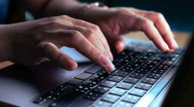 hacker or programmer hand using laptop