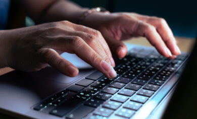 hacker or programmer hand using laptop
