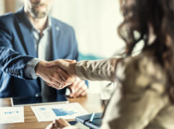 Business people shaking hands in the office. Company owner on a meeting with his employee in his office.