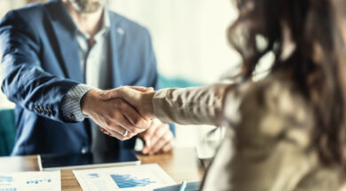 Business people shaking hands in the office. Company owner on a meeting with his employee in his office.