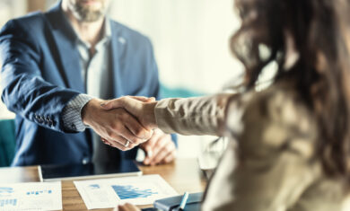 Business people shaking hands in the office. Company owner on a meeting with his employee in his office.