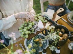 High angle view of male serving grapes at garden party