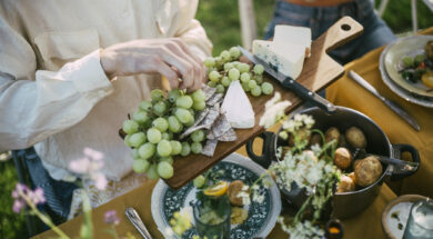 High angle view of male serving grapes at garden party