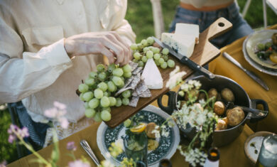High angle view of male serving grapes at garden party