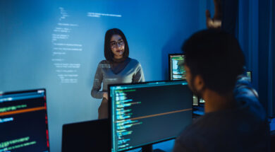 trainee developer hand up to ask speaker about software coding project presentation at night in office