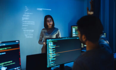 trainee developer hand up to ask speaker about software coding project presentation at night in office